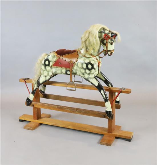 A Collinson carved and painted wood rocking horse, original paint and original cow mane and tail,